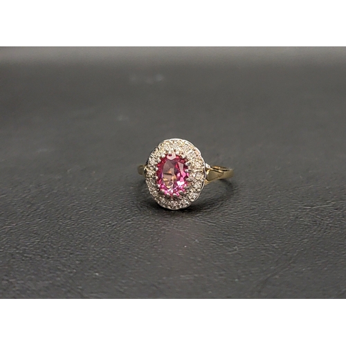 113 - PINK TOPAZ AND DIAMOND CLUSTER RING
the central oval cut topaz approximately 0.75cts in a sixteen di... 