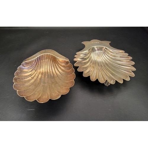 126 - TWO SILVER SHELL SHAPED TRINKET DISHES
one Victorian example by Walker & Hall, Sheffield hallmarks f... 