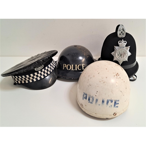 217 - FOUR POLICE HATS
including a peaked cap with the Northumberland force badge and black rain cover, No... 