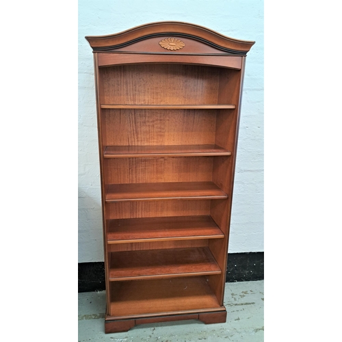 389 - MAHOGANY BOOKCASE
with an arched pediment above six shelves, standing on a shaped plinth base, 193.5... 