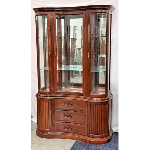 391 - TEAK SERPENTINE DISPLAY CABINET
with an illuminated upper section with three glass doors and glass s... 