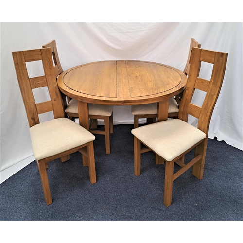 414 - CIRCULAR OAK EXTENDING DINING TABLE AND FOUR CHAIRS
the table with a pull apart top and fold out lea... 