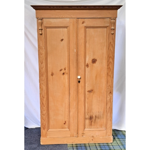 432 - STRIPPED AND WAXED PINE WARDROBE
with two panelled doors opening to reveal hanging rails and hooks w... 