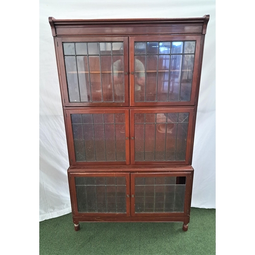 464 - SECTIONED BOOKCASE
with three pairs of leaded glass doors, standing on stout turned supports, standi... 