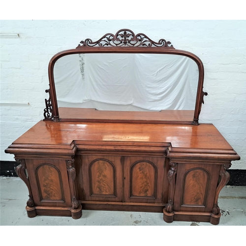 VICTORIAN MAHOGANY SIDEBOARD
the arched mirror back with carved decoration on an inverted breakfront base with three cushion frieze drawers, above a pair of central arched panelled doors flanked by a pair of arched panelled doors, one with a bottle store, standing on a plinth base, 208cm x 233cm