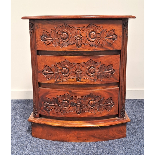 403 - BOW FRONT TEAK CHEST
with a moulded top above three carved drawers and carved side panels, standing ... 