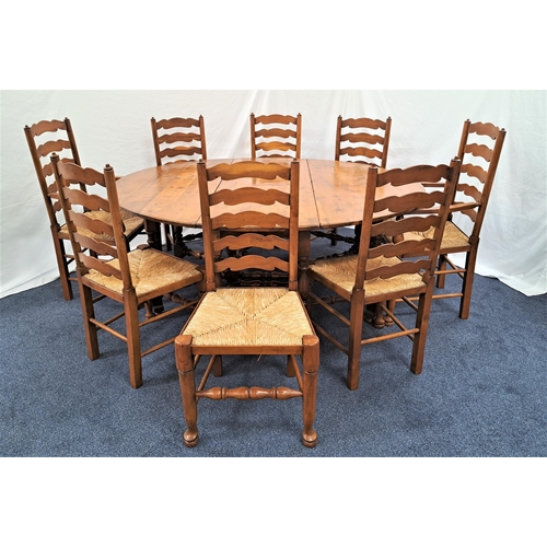 443 - IMPRESSIVE YEW GATELEG DINING TABLE
with shaped drop flaps, standing on turned supports united by a ... 