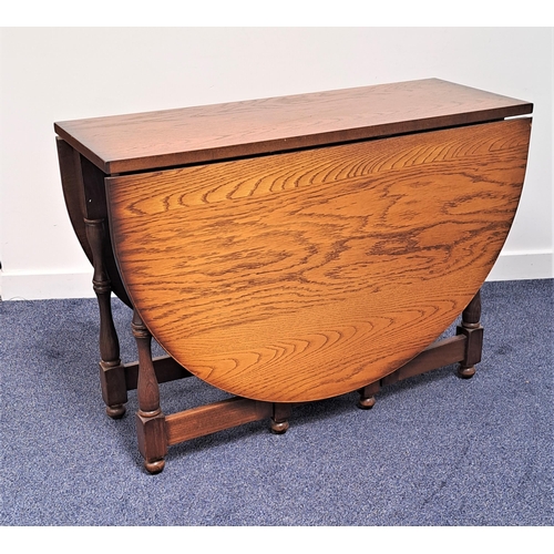 450 - OAK GATE LEG TABLE
with shaped drop flaps standing on turned supports united by a stretcher, 100cm x... 