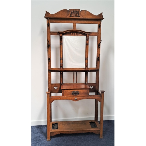 452 - 1930s OAK HALL STAND
with a shaped and carved top rail above a rectangular central mirror flanked by... 