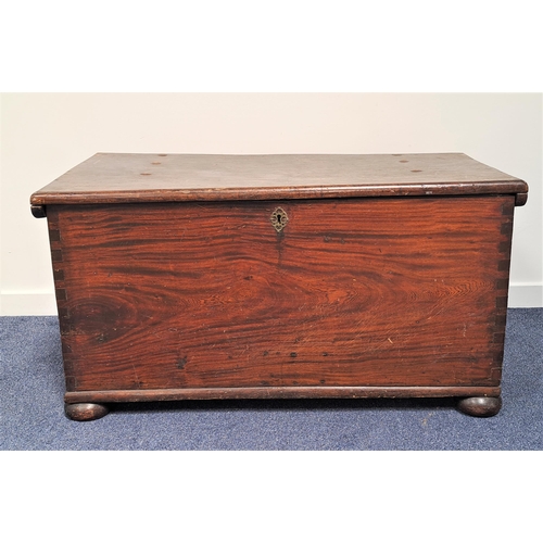 454 - LARGE TEAK CHEST
with a lift up lid and iron side carrying handles, standing on flattened bun feet, ... 