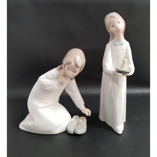 162 - TWO LLADRO FIGURINES
comprising Girl holding a candle 4868, 20.5cm high and Girl with slippers 4523,... 