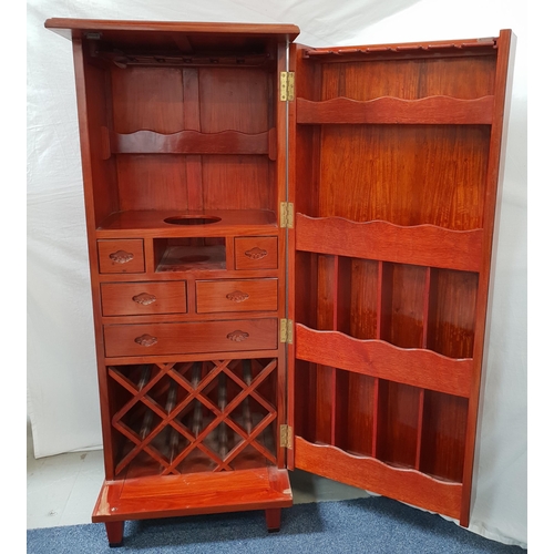 401 - LARGE TEAK DRINKS CABINET
with a panelled top and door opening to reveal drawers, ice bucket recess,... 