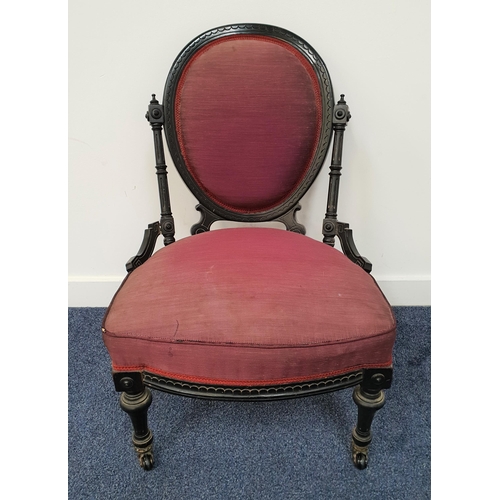 435 - AESTHETIC MOVEMENT EBONISED NURSING CHAIR
with an oval padded back above a shaped stuffover seat, st... 