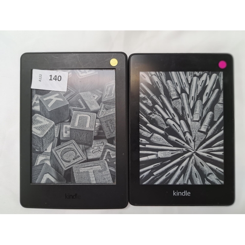 140 - TWO AMAZON KINDLE PAPERWHITE E-READERS
comprising a Paperwhite 4, serial number G000 PP10 8447 0MPL;... 