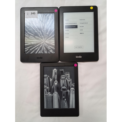 145 - THREE AMAZON KINDLE E-READERS
comprising a Paperwhite 3, serial number G090 G105 5393 03QM; a Paperw... 