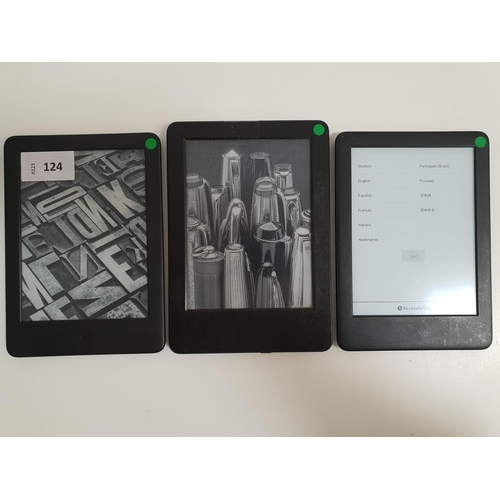 124 - THREE AMAZON KINDLE E-READERS
comprising a Basic 3, serial number G090 VB05 0137 04EC; a Basic 3, se... 