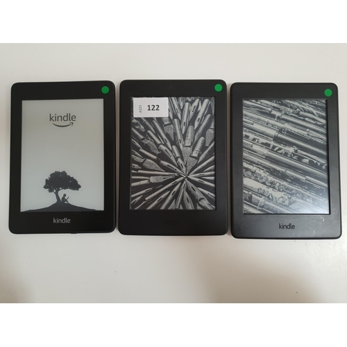 122 - THREE AMAZON KINDLE PAPERWHITE E-READERS
comprising a Paperwhite 4, serial number G000 PP13 0233 02X... 