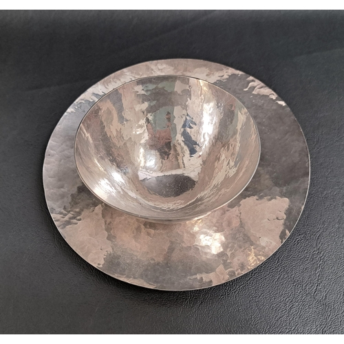 121 - 1970s SILVER DISH
of circular hammered form, 16cm diameter; together with a similar silver hammered ... 