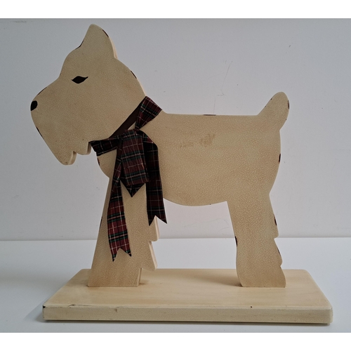 173 - NOVELTY WOODEN DOOR STOP
in the form of a West Highland terrier in profile, on a rectangular base, 4... 