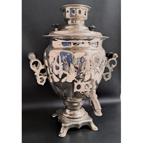 190 - RUSSIAN SILVER PLATED SAMOVAR
with shaped side handles and raised on a shaped base with four scroll ... 