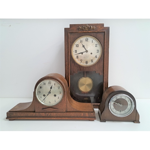 211 - THREE WOODEN CLOCKS
comprising a stained pine regulator wall clock, 56cm high; an oak cased Napoleon... 