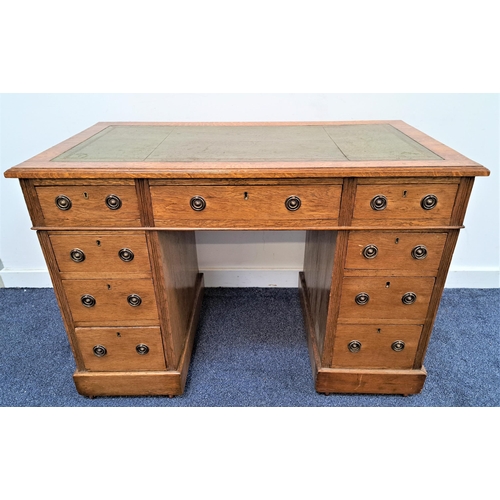 352 - EDWARDIAN OAK PEDESTAL DESK
with an inset green leather top above an arrangement of nine drawers, 73... 