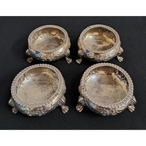 133 - SET OF FOUR VICTORIAN SILVER SALTS
decorated with embossed floral decoration and raised on paw feet,... 