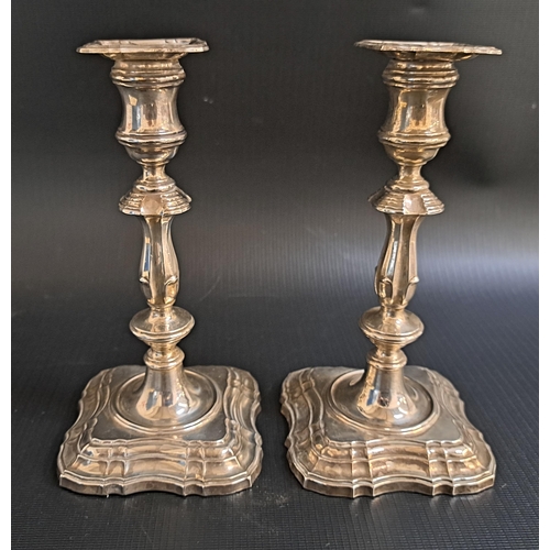 134 - PAIR OF GEORGE V SILVER CANDLESTICKS
with knopped stems and raised on shaped square bases, with remo...