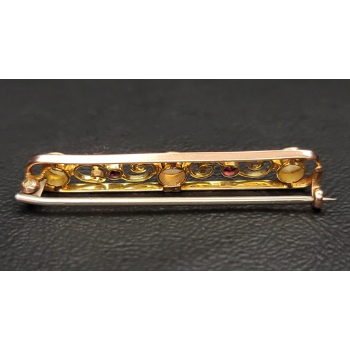 4 - PRETTY OPAL AND RUBY NINE CARAT GOLD BAR BROOCH
the pierced brooch with scroll detail, 3.8cm wide