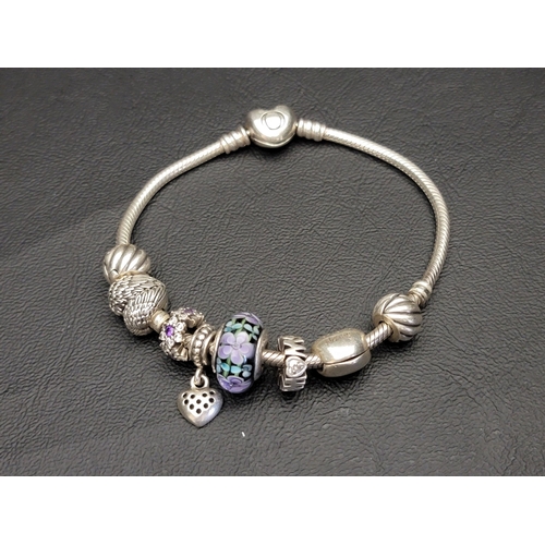 114 - PANDORA MOMENTS HEART CLASP SNAKE CHAIN BRACELET
with eight charms including two Polished Feather Cl... 