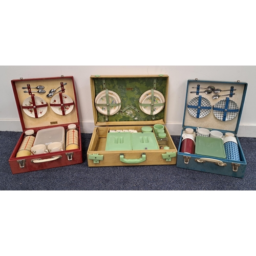 233 - THREE VINTAGE BREXTON PICNIC HAMPERS
with various cups, plates, cutlery and flasks in the fitted int... 