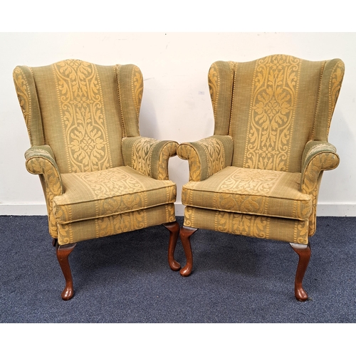 348 - PAIR OF PARKER KNOLL WING BACK ARMCHAIRS
covered in a green and yellow textured fabric, standing on ... 