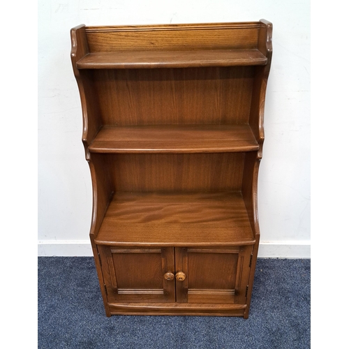 372 - ERCOL ELM WATERFALL BOOKCASE
with two open shelves and shaped sides above a pair of panelled cupboar... 