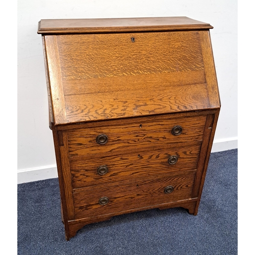 385 - OAK BUREAU
with a fall flap opening to reveal a fitted interior above three graduated drawers, stand... 