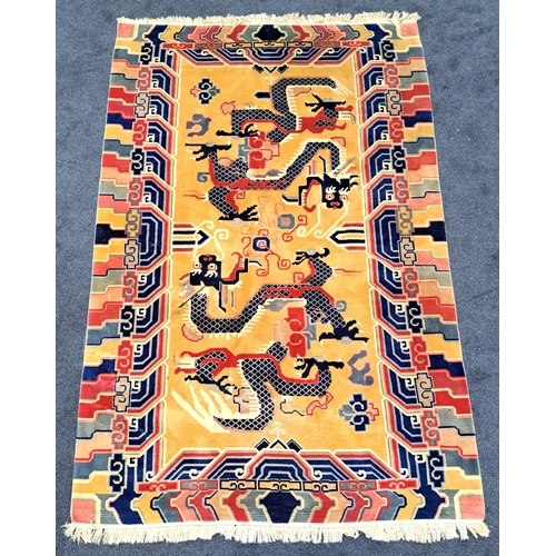 398 - VINTAGE TIBETAN RUG
with a yellow ground centred with two dragons and encased by a vibrant border, 2... 