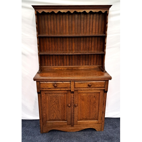 400 - OAK FARMHOUSE DRESSER
with a carved pediment above two plate racks with shaped sides, the base with ... 