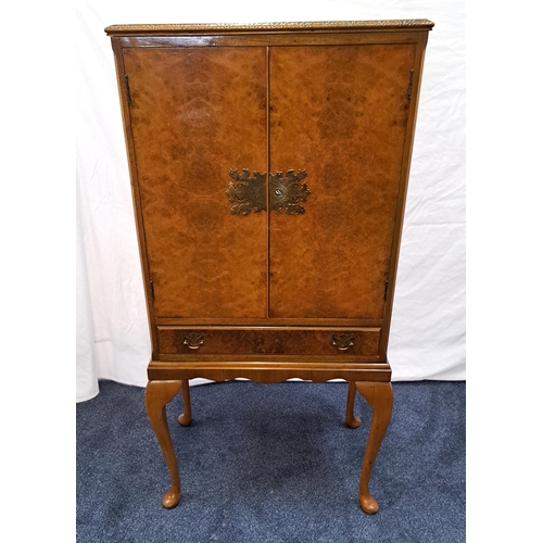 419 - BURR WALNUT DRINKS CABINET
with a moulded top above canted corners flanking a pair of cupboard doors... 