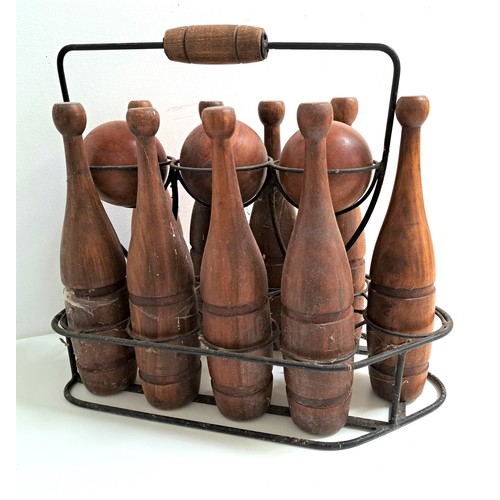 219 - VINTAGE TEAK BOWLING SET
comprising three balls and nine shaped skittles, contained in a metal frame... 