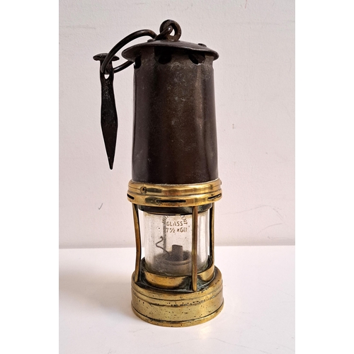 241 - VINTAGE MINERS LAMP
with a steel and brass body, the suspension loop with an attached masonry nail