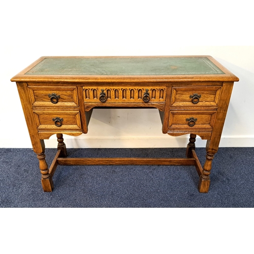 369 - OAK KNEEHOLE DESK
with a tooled green leather inset top above an arrangement of five carved and pane... 