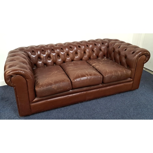 409 - CHESTERFIELD SOFA
in brown leather with a button back and scroll arms with three loose seat cushions... 