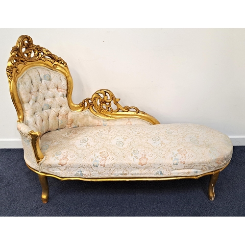 413 - ORNATE GILT WOOD CHAISE LOUNGE
with a button back covered in a floral brocade, standing on gilt wood... 