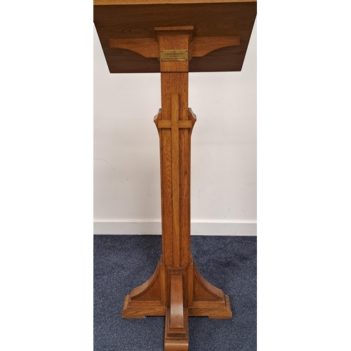 436 - CARVED OAK ECCLESIASTICAL LECTURN
with a sloping book rest on a square column with a brass memorial ... 