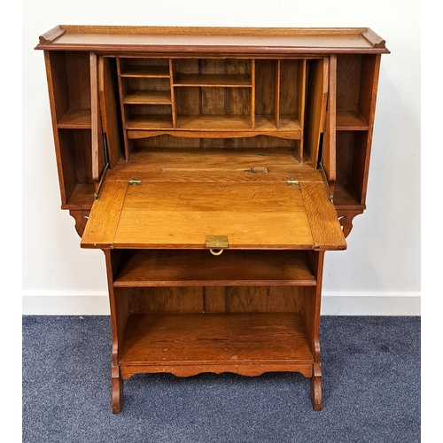 441 - ARTS AND CRAFTS OAK BUREAU
with a galleried top above a fall flap with ornate brass hinges and handl... 