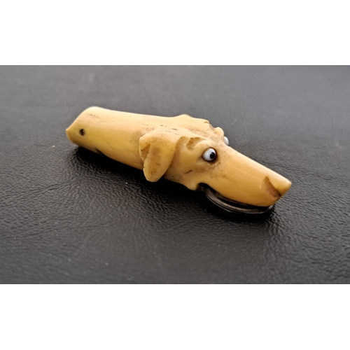 242 - 19th CENTURY BONE DOG WHISTLE
modelled as a hound with bead eyes and suspension ring to the mouth, 6... 