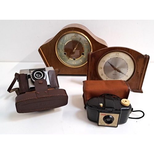 245 - TWO CLOCKS AND TWO CAMERAS
comprising a Westminster chime mantel clock, a Westclox mantel clock, a K... 