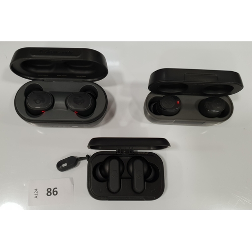 86 - THREE PAIRS OF SKULLCANDY EARBUDS IN CHARGING CASES