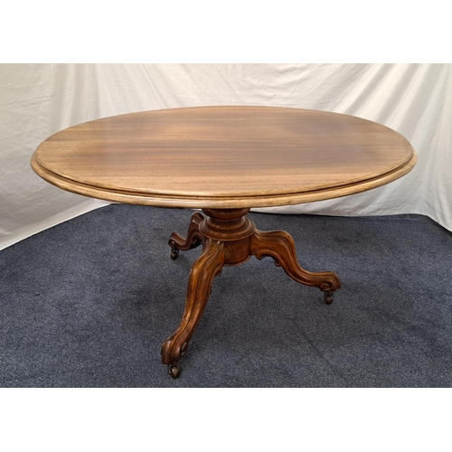 446 - VICTORIAN MAHOGANY LOO TABLE
with an oval tilt top on a turned column with three scroll supports wit... 