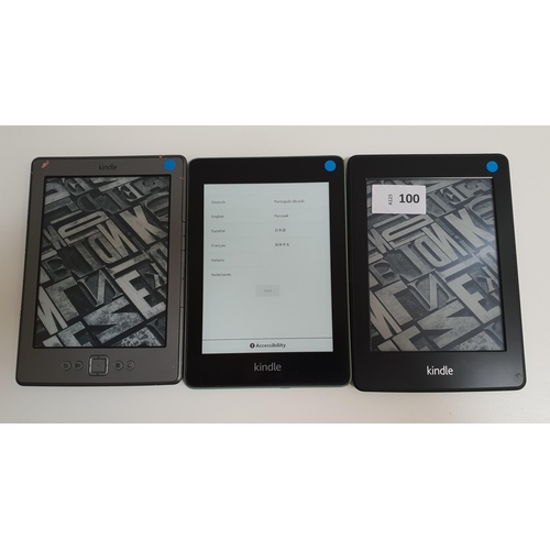 100 - THREE AMAZON KINDLE E-READERS
comprising a Paperwhite wifi, serial number B024 1604 3217 02QK; a Pap... 