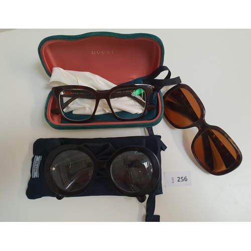 256 - TWO PAIRS OF DEISGNER GLASSES AND ONE PAIR OF SUNGLASSES
comprising a pair of Prada glasses, a pair ... 